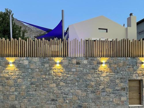 a brick wall with lights on top of it at THE AA VILLA: Your Interactive Home Experience! in Kastamonítsa