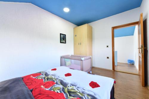 a bedroom with a bed and a sink in it at Natura hause in Rakovica