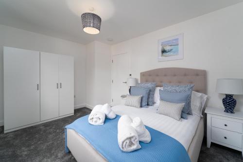 a bedroom with two beds with towels on them at Tides in Carbis Bay