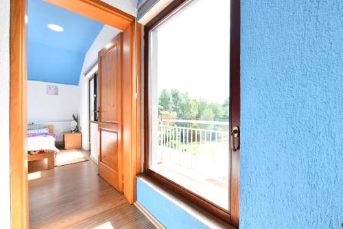 an open door to a balcony with a window at Natura hause in Rakovica