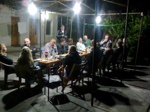 a group of people sitting at a table at night at Giorgi's Homestay in Kutaisi