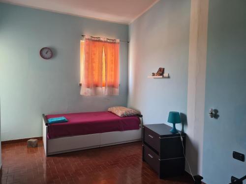 a small bedroom with a bed and a window at LunaMarina in Marinella di Sarzana