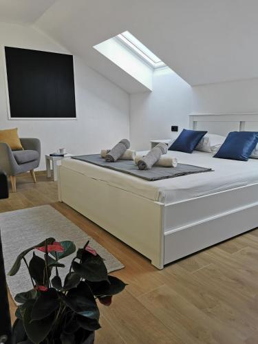 a bedroom with a large bed with a flat screen tv at Guesthouse Korkyra Sun in Korčula