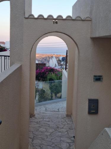 an archway in a building with a view of the ocean at Gorgeous SeaView house in Pissouri