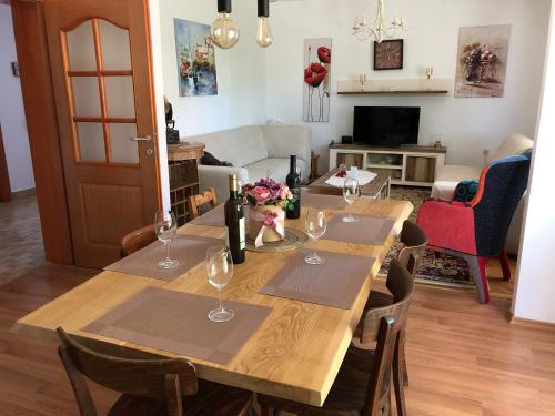 a dining room with a table with wine glasses at Villa Emili in Posušje