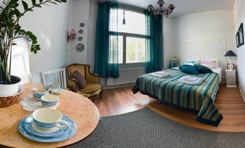 a bedroom with a bed and a table with dishes on it at Salpalinjan Hovi in Lappeenranta