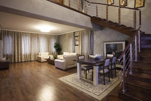 a living room with a table and a dining room at Gashalti Health Hotel Naftalan in Naftalan