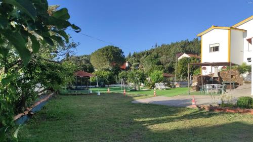 a park with a tennis court and a playground at Visitar Bioucas I - Casa Inteira Familiar in Bioucas