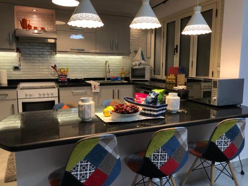 a kitchen with a counter with a bowl of fruit on it at Lazorde Beachfront Experience in El Alamein