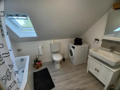 a bathroom with a sink and a toilet and a window at Bredeney View in Essen