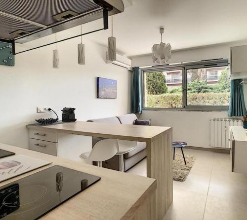 a kitchen with a counter and a table in a room at Studio - 1 minute de la plage et de la Promenade des Anglais in Nice