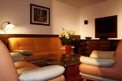 a living room with a couch and a table at Hotel Barbakan in Trnava