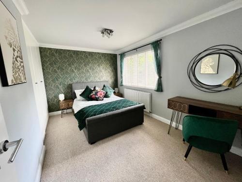 a bedroom with a bed and a mirror and a desk at Modern Home, Close to the City Centre with Parking in Birmingham