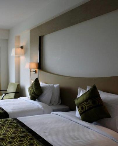 a hotel room with two beds and a large window at Gurmon Hotels Sohna Road Gurugram, a member of Radisson Individuals in Sohna