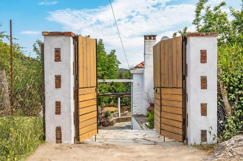 an entrance to a house with wooden doors at La Belle Merle in Panormos Skopelos