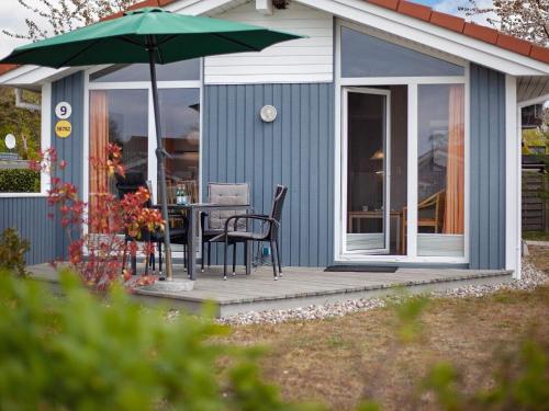 a patio with a table and an umbrella at 4 person holiday home in GROEMITZ in Grömitz