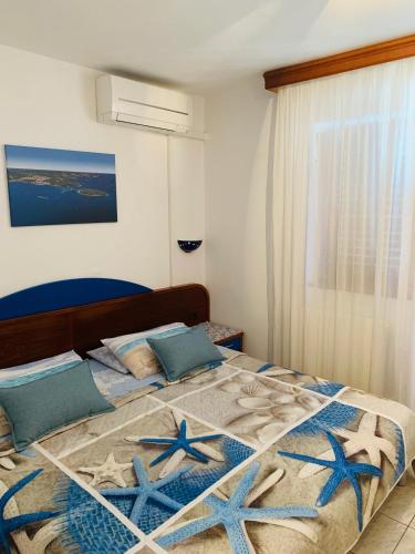 a bedroom with a bed with blue stars on it at FUNTANA-MIA ROOMS B&B in Funtana