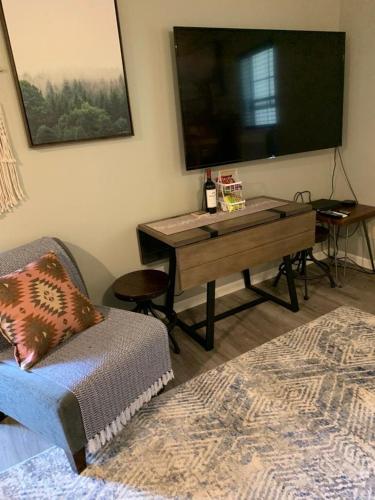 a room with a table and a couch and a tv at YoBee! Park Reservation Included! Heart of Yosemite - Homey Studios and Breakfast in Yosemite West