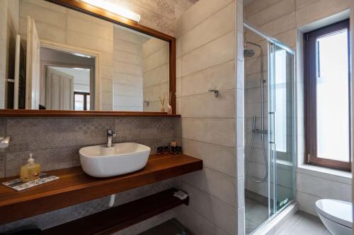 a bathroom with a sink and a glass shower at Ιkia Zmas in Argalasti