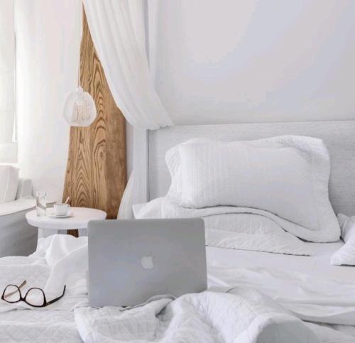 a laptop computer sitting on top of a bed at Art riad mazighen in El Jadida