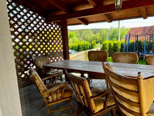 a wooden table and chairs on a patio at Chalupa Kadov in Sněžné