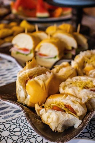 a plate of food with sandwiches on a table at Pousada Vila do Cowboy in Penha