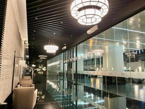 a large building with glass windows and chairs and lights at Luxurious Condotel at the heart of Makati in Manila