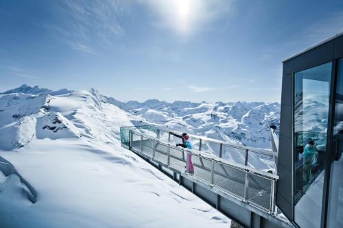 a building on top of a snow covered mountain at Ski Dome Apartments-Apartment VIVA & Heaven Holiday Chalet in Kaprun