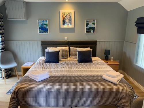 a bedroom with a large bed with towels on it at Gracehill Lodge - Guest Accommodation in Stranocum