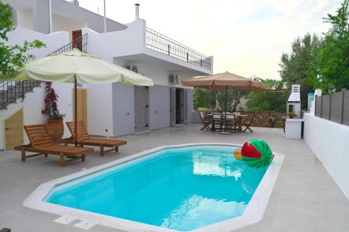 a swimming pool with a toy in the middle of a house at Giovana's pool house in Aegina Town