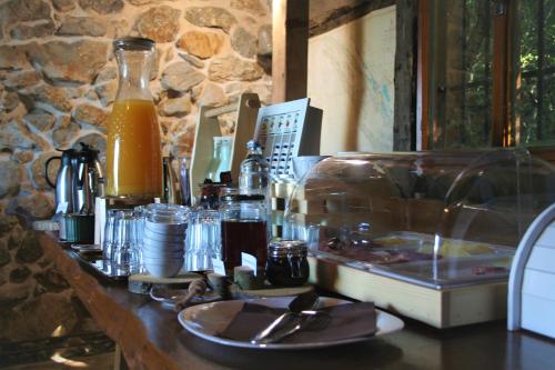 a table with a glass counter top with food and drinks at Boutique B&B Agroturizam Sv. Juraj in Krk