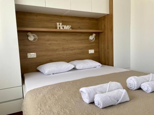 a bedroom with a bed with towels on it at La Mer Apartments Kotor in Kotor