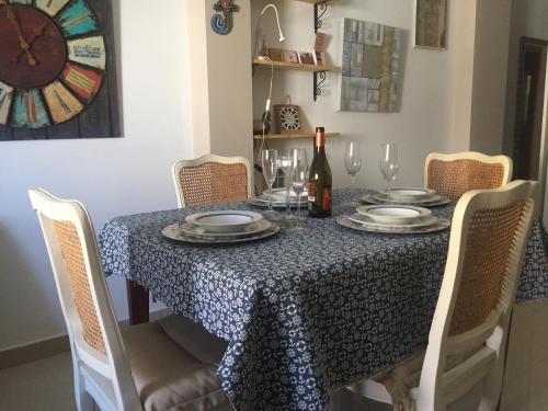 a dining room table with a blue and white table cloth at Casa Barbara El Cotillo in Cotillo