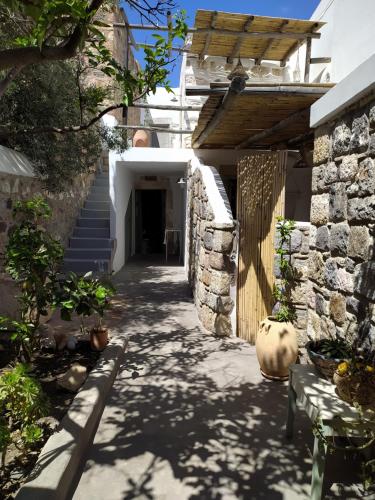 a hallway of a house with a stone wall at Latmos 1860 in Skala