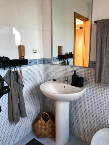 a bathroom with a white sink and a mirror at Villa Vanilla charming family house in Lajares
