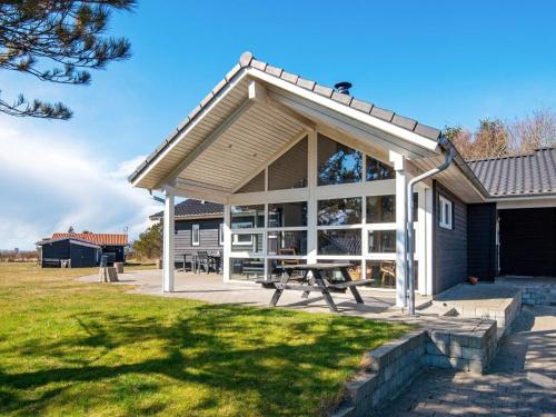 a pavilion with a picnic table in a park at 10 person holiday home in L gst r in Trend