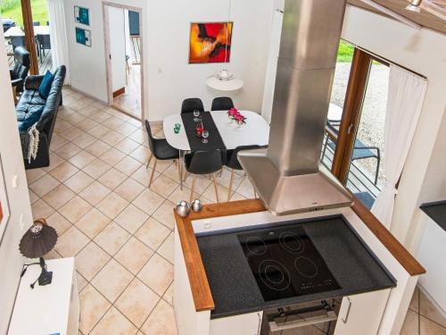 an aerial view of a kitchen with a stove and a table at 8 person holiday home in Ulfborg in Thorsminde