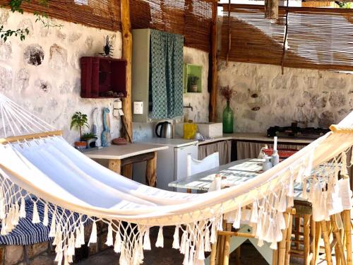 a room with a hammock in a kitchen at Latmos 1860 in Skala