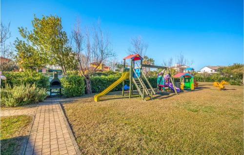 a playground with a slide in a park at 3 Bedroom Cozy Home In Albarella Ro in Isola Albarella
