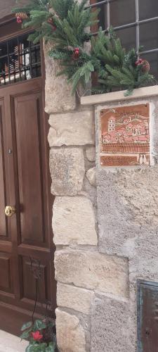 Una porta per un edificio con un natalizio e un cartello di casa vacanze belvedere a Sermoneta