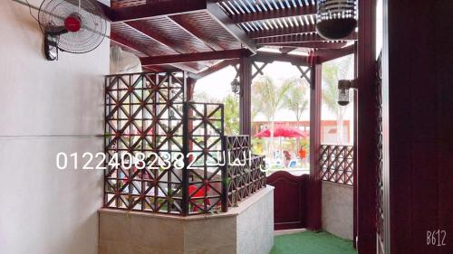 a patio with a wooden pergola on a building at paradise porto said garden challet for families in Port Said