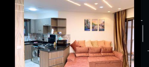 a living room with a couch in a kitchen at paradise porto said garden challet for families in Port Said