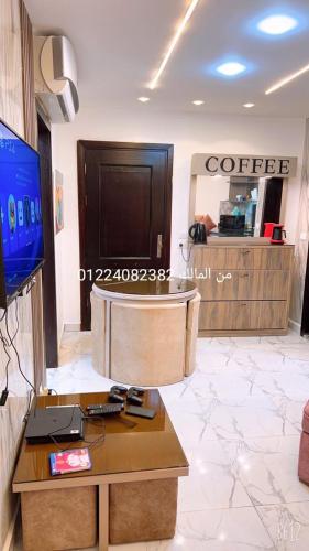 a coffee shop with a coffee table in a room at paradise porto said garden challet for families in Port Said