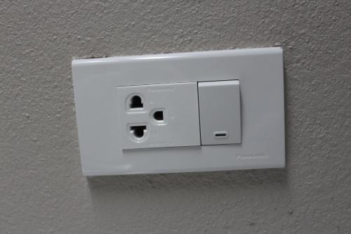 a white light switch on a wall at Grand Mansion Hotel in Krabi town