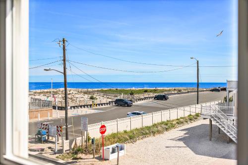 a view from a window of a road and the ocean at The Hideaway Hotel in Long Beach