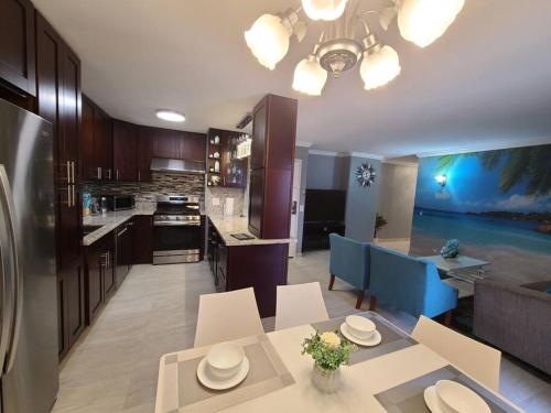 a kitchen and dining room with a table and chairs at Lovely Condo 2 Bedrooms, 2 bathrooms, free 1 Parking at Waikiki Beach in Honolulu