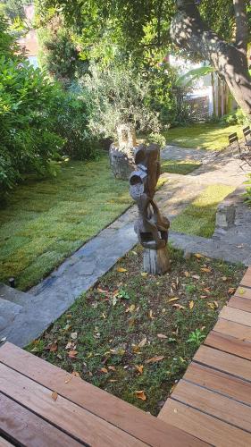 a statue of a fire hydrant in a yard at Secret garden of Piran in Piran