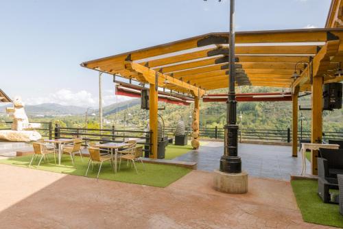a patio with tables and chairs and a view at Complejo Hostelero Paladium in Villamartín