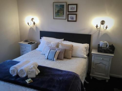 a bedroom with a bed with towels on it at Royal Mail Hotel in Lumsden