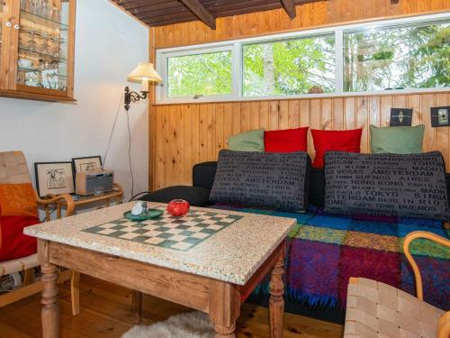 a living room with a checkered table and a couch at 4 person holiday home in Grenaa in Grenå